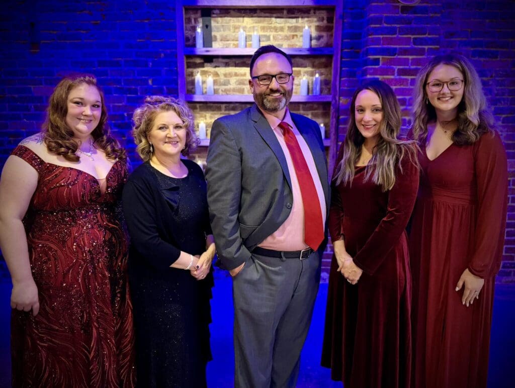 A photo of five members of ATFCU's staff at the event. They are dressed in festive party attire.